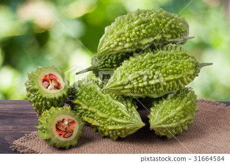 heap of bitter melon or momordica on wooden table 31664584