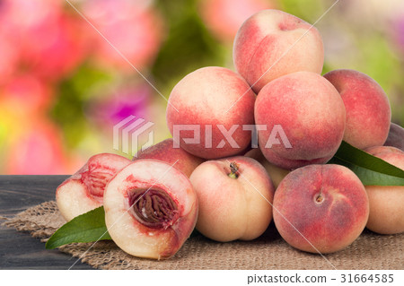 heap of peaches on a wooden table with blurred 31664585