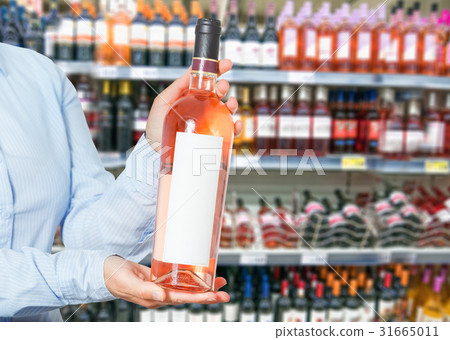 woman buys wine in shop woman buys wine in shop 31665011