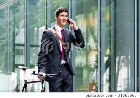 Young confident man talking on mobile phone afte Young confident man talking on mobile phone afte 31665663