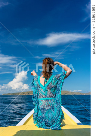 Young woman looking away to the horizon while 31665693