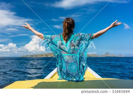 Rear view of a young woman enjoying summer Rear view of a young woman enjoying summer 31665694