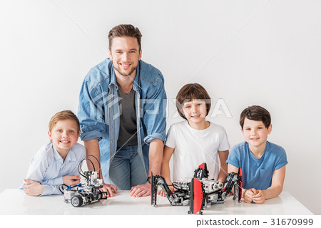 Cheerful smiling technician team in workshop Cheerful smiling technician team in workshop 31670999