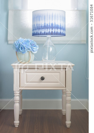 Flower jar and reading lamp on bedside table Flower jar and reading lamp on bedside table 31671084