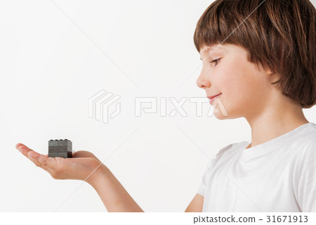 Kindly smiling child presenting plaything Kindly smiling child presenting plaything 31671913