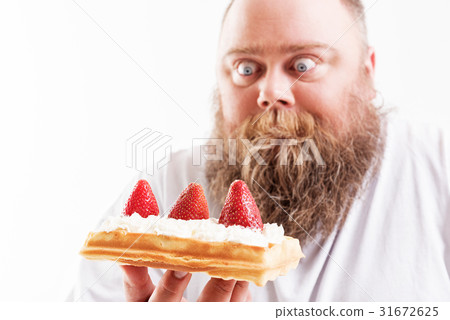 Starving fat man looking at dessert with shock 31672625