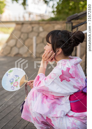 A woman walking through the streets of Hakata A woman walking through the streets of Hakata 31672880