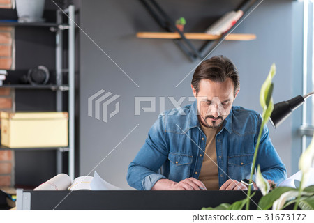 Serious man working on project 31673172