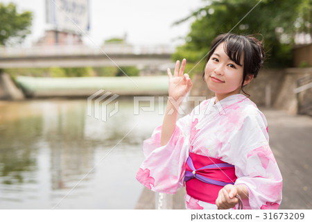 A woman walking through the streets of Hakata A woman walking through the streets of Hakata 31673209