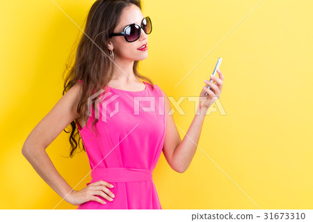 Young woman using her phone Young woman using her phone 31673310