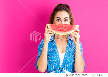 Happy young woman holding watermelon 31673316