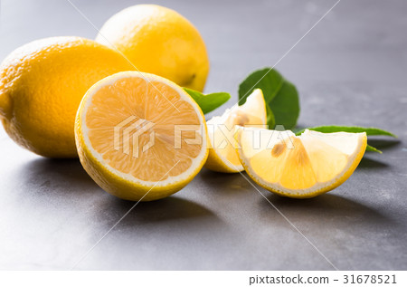 fresh sliced lemon on dark marble stone 31678521
