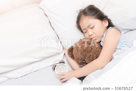 cute little asian girl sleep and hug teddy bear 31678527