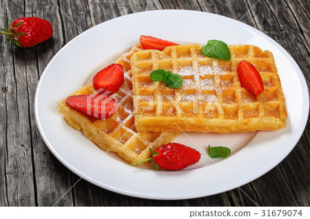 Belgian waffles with strawberries Belgian waffles with strawberries 31679074