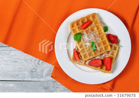 Belgian waffles with strawberries Belgian waffles with strawberries 31679078