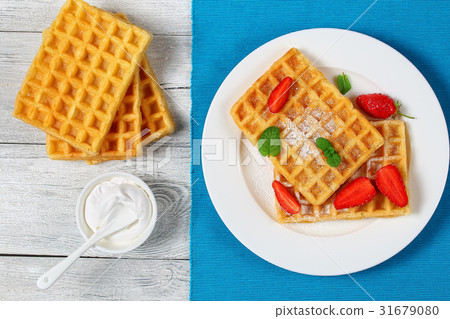 Belgian waffles with strawberries Belgian waffles with strawberries 31679080