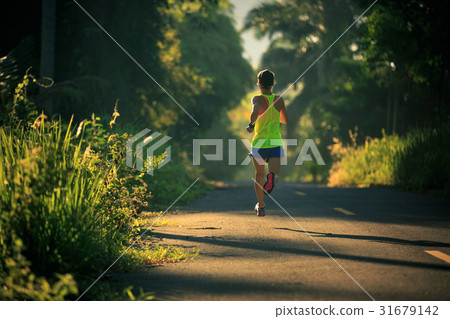 runner warming up before running at forest trail 31679142