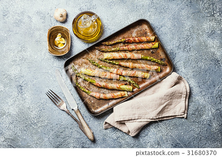 Grilled green asparagus wrapped with bacon Grilled green asparagus wrapped with bacon 31680370