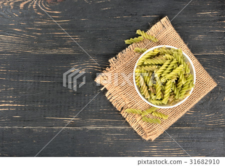 Green pasta fusilli in bowl 31682910