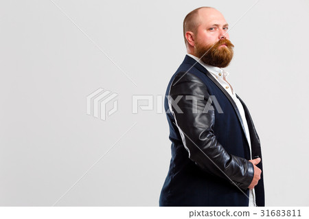 Man with beard stands sideways Man with beard stands sideways 31683811