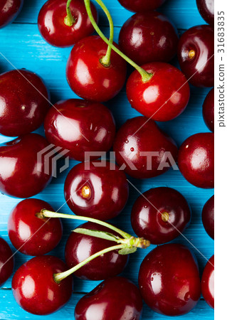 crowded group of ripe cherries, making approach 31683835