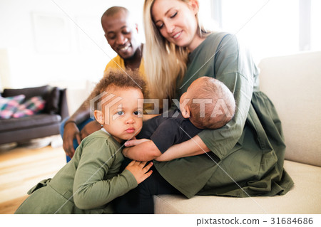 Young interracial family with little children at 31684686