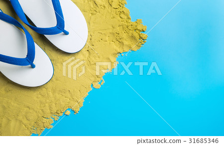 White Sandals on brown sand on blue copy space White Sandals on brown sand on blue copy space 31685346