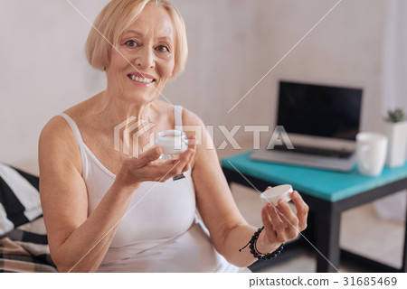 Experienced woman showing her new cream Experienced woman showing her new cream 31685469
