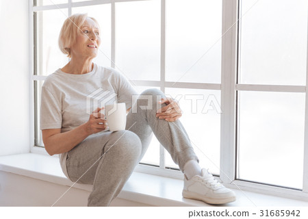 Relaxed woman looking through the window 31685942