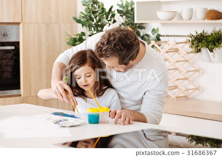 Father helping his daughter in painting Father helping his daughter in painting 31686367