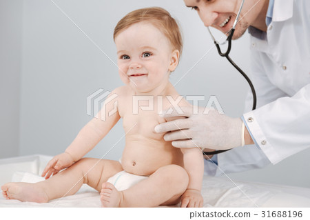 Sweet joyful toddler liking the procedure 31688196