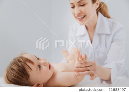 Cute distinguished pediatrician smiling during the Cute distinguished pediatrician smiling during the 31688497