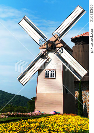 Wooden windmill on blue sky background Wooden windmill on blue sky background 31688596