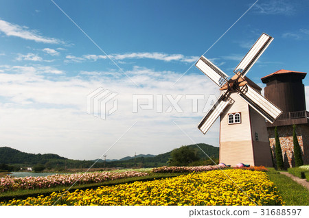 Wooden windmill on blue sky background Wooden windmill on blue sky background 31688597