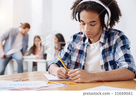 Persistent talented young student making notes Persistent talented young student making notes 31689081