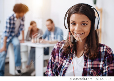 Admirable productive young lady wearing headphones 31689208