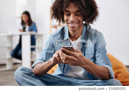 Positive talkative guy chatting with his friends 31689291