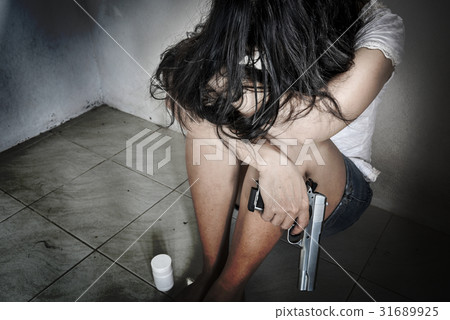 Sadness women with a handgun make to suicide 31689925