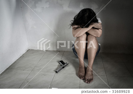 Sadness women with a handgun decided to suicide 31689928