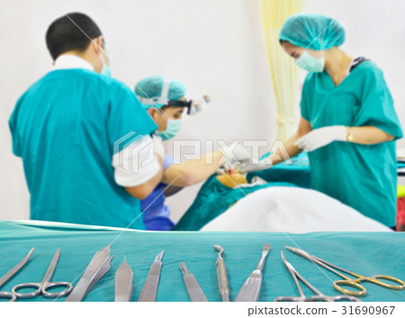Team surgeon at work in the operating room. Team surgeon at work in the operating room. 31690967
