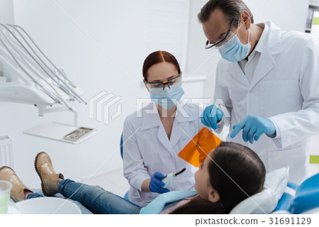 Two dentists wearing sterile masks Two dentists wearing sterile masks 31691129