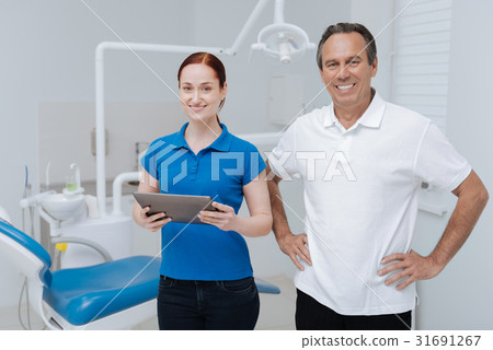 Attractive female person holding gadget in both Attractive female person holding gadget in both 31691267