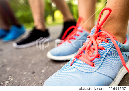 Legs of young athletes prepared for run in green 31691567