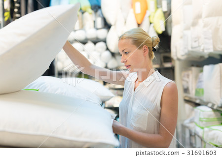 Woman choosing the right item for her apartment in Woman choosing the right item for her apartment in 31691603
