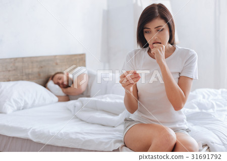 Young woman kicking herself while looking at 31691792