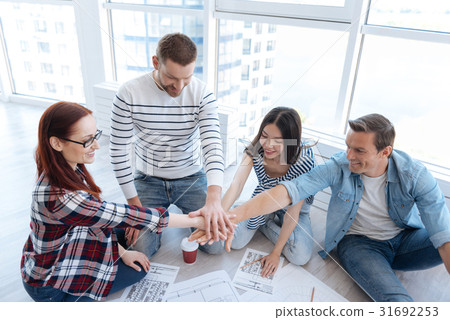 Joyful positive people holding their hands Joyful positive people holding their hands 31692253