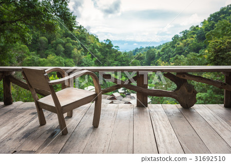 Wooden armchair on terrace inside rainforest Wooden armchair on terrace inside rainforest 31692510
