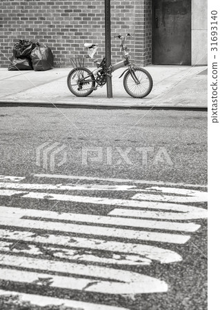 An old bicycle locked to a sign post in Chinatown. An old bicycle locked to a sign post in Chinatown. 31693140