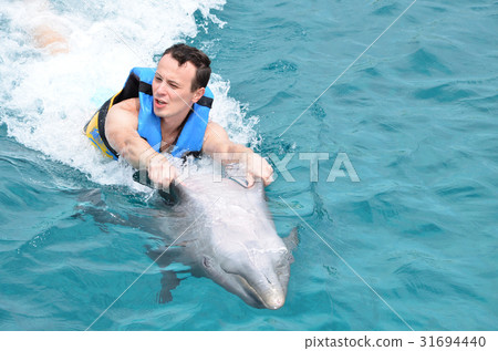 man holding dolphin fins 31694440