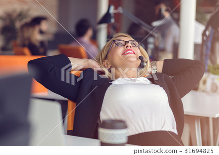 Beautiful young woman holding hands behind head 31694825